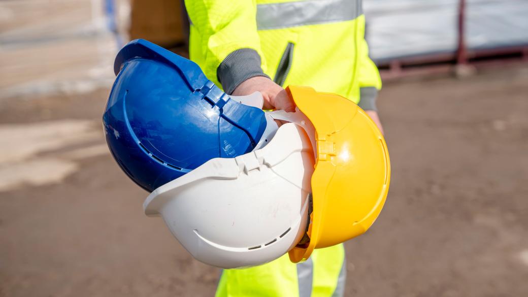 Contractor carrying safety helmets