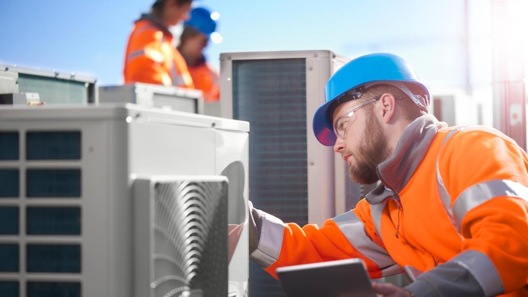 Air conditioning control technician installing HVAC Unit