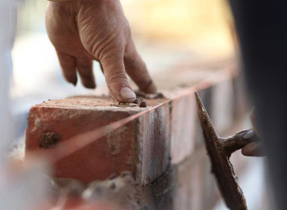 A bricklayer constructing a new wall