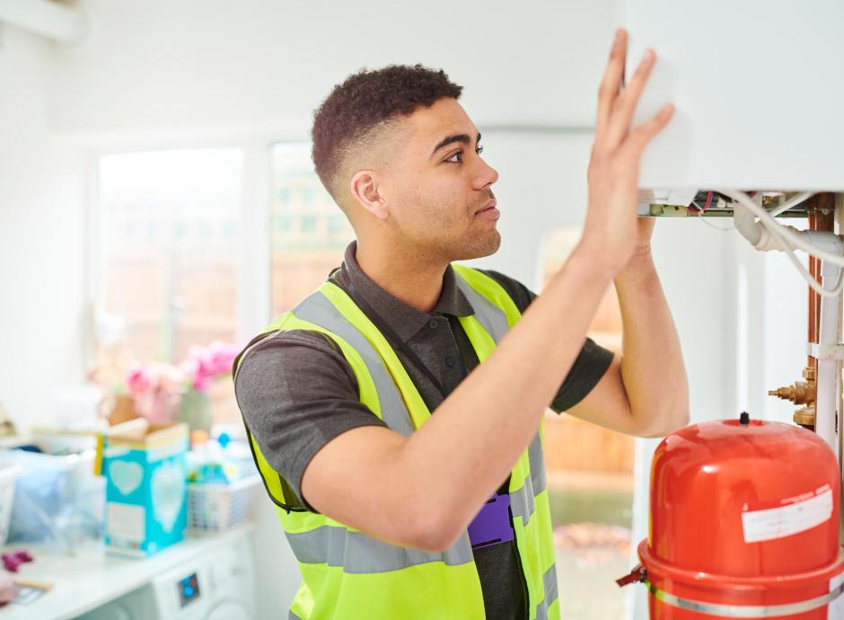 Heating engineer installing new gas boiler