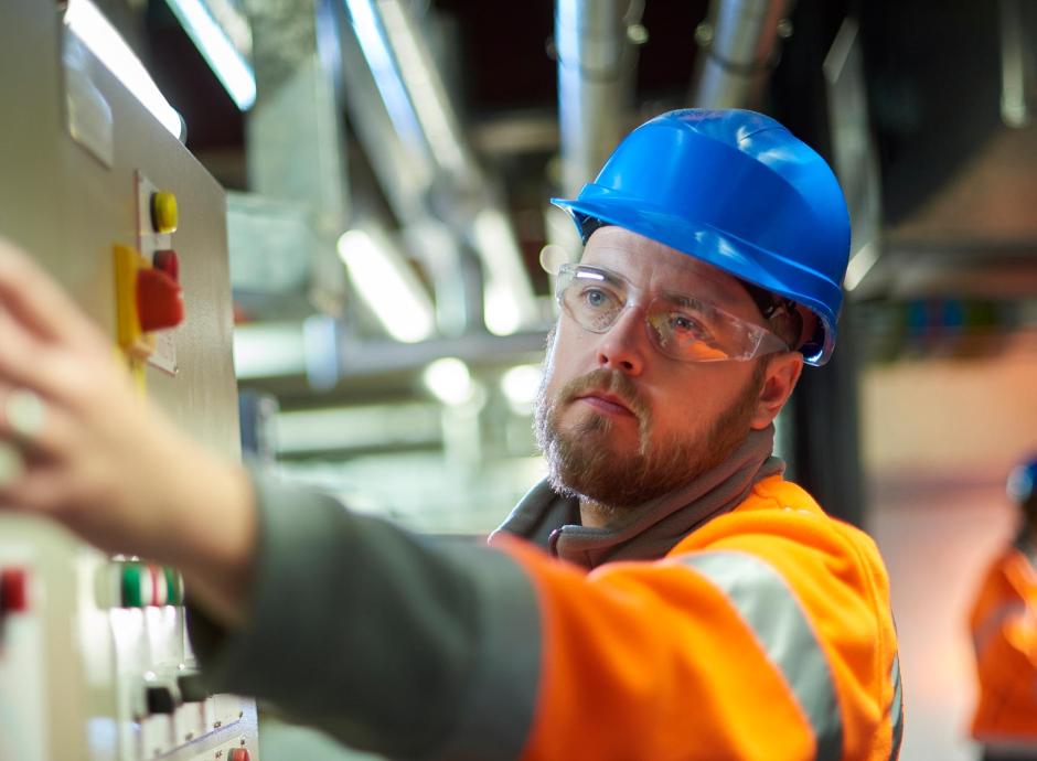 Engineer servicing an industrial air conditioning unit