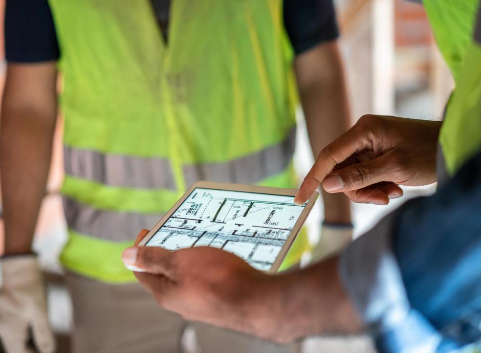 Construction workers viewing plans on an ipad